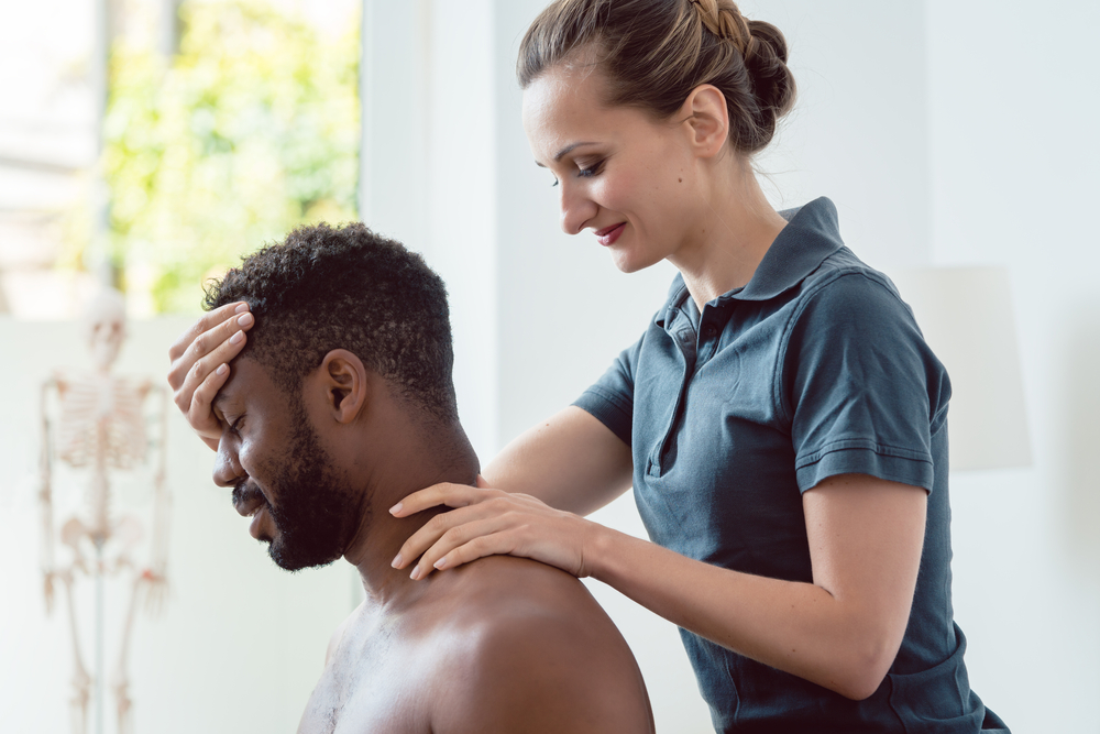 How Can Shoulder Pain Hinder Your Everyday Life?  - Woman physical therapist massaging young man